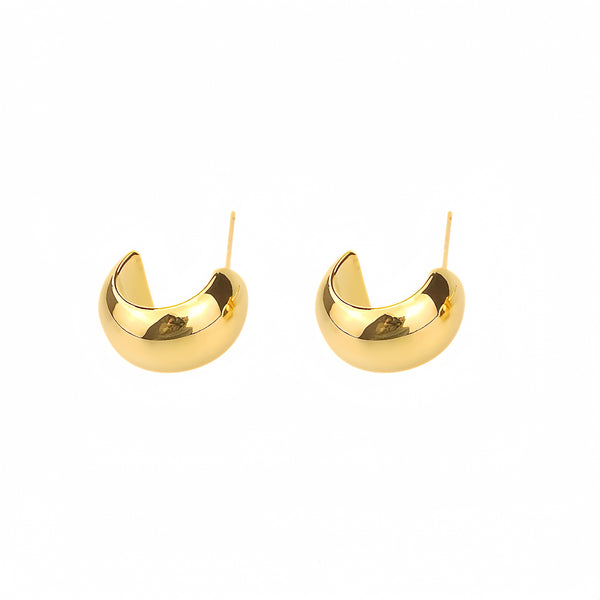 Eye-catching hoop earrings in warm 14K gold. The large, curved hoops have a tapered, wider base. Polished to a gleaming finish, the earrings fasten with friction clasps for a secure fit.  Materials: Eco Brass 18K Gold / White Gold Plating