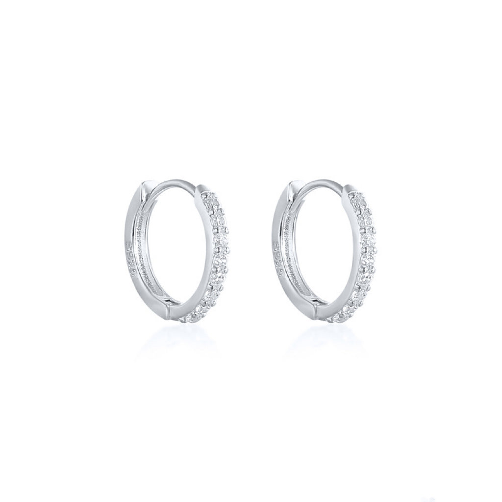 These Sparkly Pave Huggies gently curve around the lobe, adorned with an assortment of dazzling cubic zirconia. Wear them to instantly elevate and brighten your look!  Materials: High Quality Solid 925 Sterling Silver 5A Cubic Zirconia&nbsp; 18K Gold / White Gold Plating